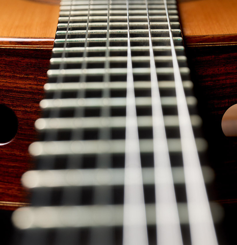View of the soundports from the fingerboard of a 2003 Robert Ruck classical guitar made of spruce and Indian rosewood