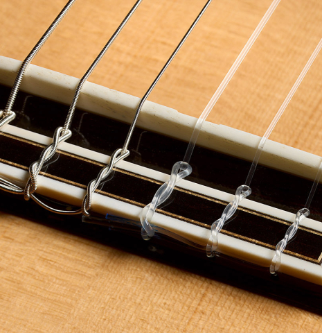 The bridge, tie-block and saddle of a 2003 Robert Ruck classical guitar made of spruce and Indian rosewood