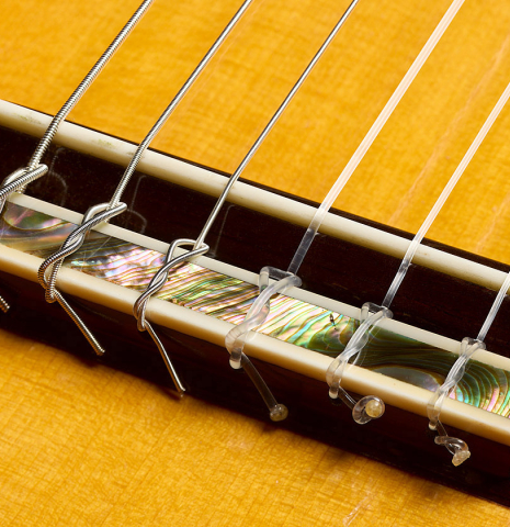 The bridge, tie-block and saddle of a 1979 Robert Ruck classical guitar made of spruce and CSA rosewood