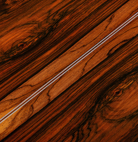The back center seam of a 2024 Eric Sahlin classical guitar made of cedar and CSA rosewood