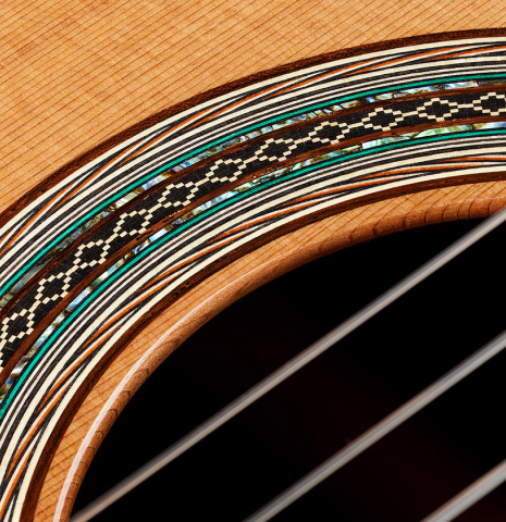 Detailed closeup of the rosette of a 2024 Eric Sahlin classical guitar made of cedar and CSA rosewood