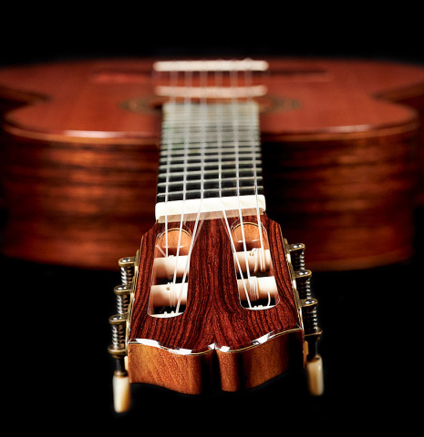 The twisted fretboard of a 1994 Eric Sahlin classical guitar made of cedar and Indian rosewood.