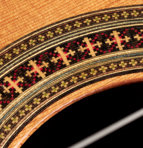 The rosette of a 1994 Eric Sahlin classical guitar made of cedar and Indian rosewood.