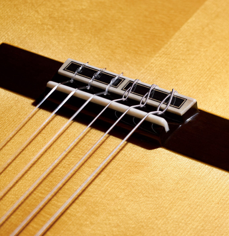 The bridge, saddle and tie-block of a 2023 Masaki Sakurai "Special" classical guitar made with spruce and CSA rosewood.