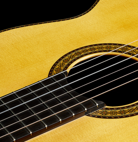 The soundboard and rosette of a 2024 Masaki Sakurai "Special" classical guitar made with spruce and African rosewood.