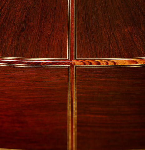 The back, sides, bindings and purflings at the foot of a 2025 Masaki Sakurai "Special" classical guitar made of cedar and African rosewood