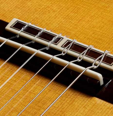 The bridge, tie-block and saddle of a 2025 Masaki Sakurai "Special" classical guitar made of cedar and African rosewood