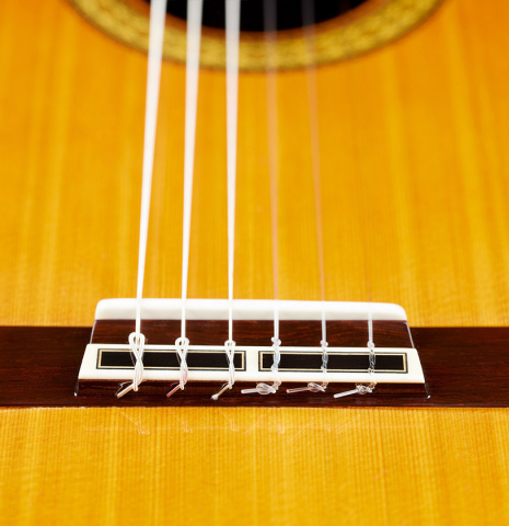 The bridge, tie-block and saddle of a 2024 Masaki Sakurai "Special 640" classical guitar made of cedar and African rosewood