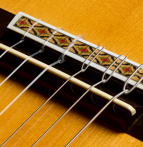 The bridge, tie-block and saddle of a 1982 Masaki Sakurai "Concert" classical guitar made of spruce and CSA rosewood