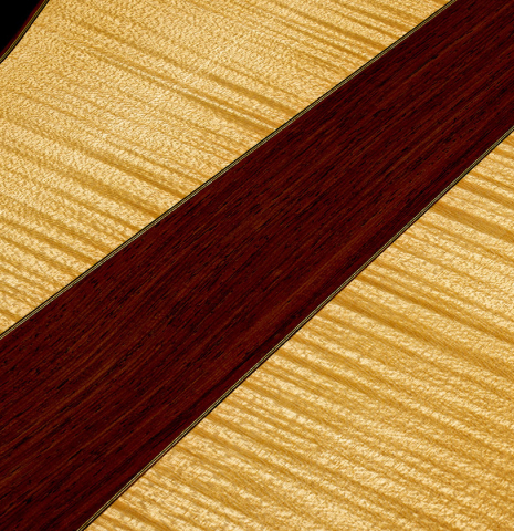 The beck center wedge of a 2022 Douglass Scott "635" classical guitar made of spruce and maple