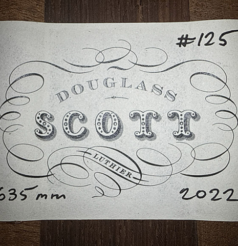 The label of a 2022 Douglass Scott "635" classical guitar made of spruce and maple