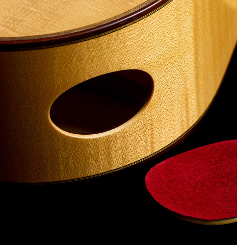 The soundport and lid of a 2022 Douglass Scott "635" classical guitar made of spruce and maple