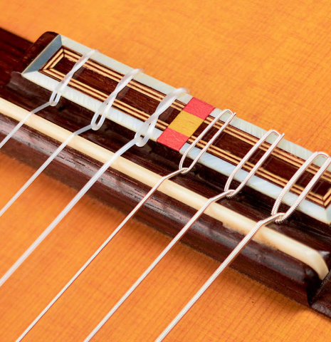 The bridge and saddle of a 2016 Federico Sheppard “Simplicio 1927, ex Barrios” (ex Pavel Steidl) classical guitar made with spruce and CSA rosewood