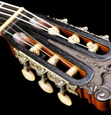 The carved headstock of a 1925 Francisco Simplicio made with spruce and CSA rosewood.