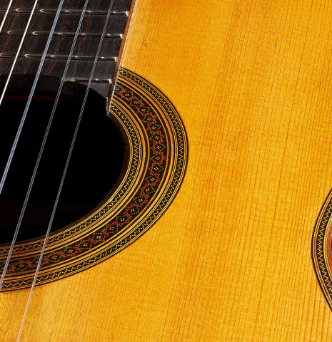 The top and rosette detail of a 1929 Francisco Simplicio classical guitar made of spruce and satinwood