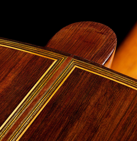 The heel, back binding and purflings of a 1923 Francisco Simplicio classical guitar made of spruce and CSA rosewood