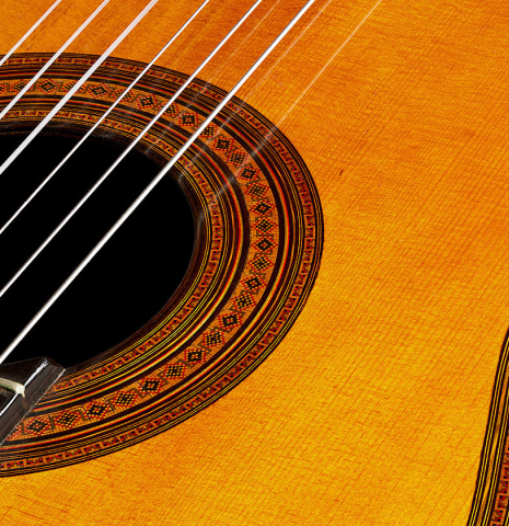 The top and rosette detail of a 1923 Francisco Simplicio classical guitar made of spruce and CSA rosewood
