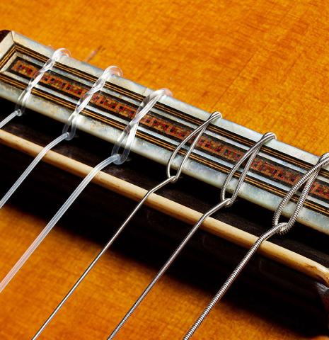 The bridge, tie-block and saddle of a 1923 Francisco Simplicio classical guitar made of spruce and CSA rosewood