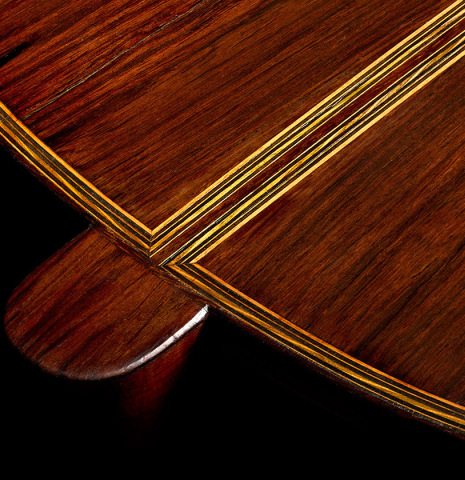 The heel, back binding and purflings of a 1926 Francisco Simplicio classical guitar made of spruce and CSA rosewood