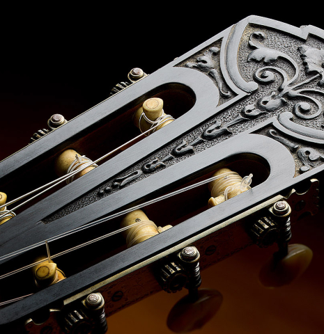 The carved headstock and tuners of a 1926 Francisco Simplicio classical guitar made of spruce and CSA rosewood