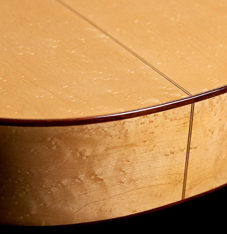 The lower bout of a 2019 Youri Soroka "Torres" classical guitar made with spruce and maple.