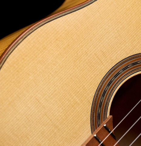 The soundboard and rosette of a 2020 Youri Soroka classical guitar made with spruce top and maple back and sides.