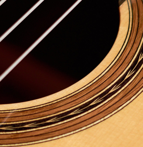 The close-up of a rosette of a 2022 Youri Soroka &quot;Templars Oak&quot; classical guitar made with spruce top and oak back and sides
