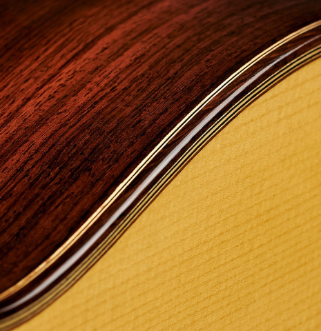 Closeup of the binding and purling of the top and sides of a 2023 Youri Soroka "1924 Santos, ex Segovia" classical guitar made of spruce and Indian rosewood