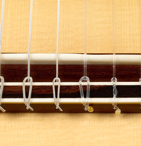 The bridge, tie-block and saddle of a 2025 Youri Soroka classical guitar made of spruce and African rosewood