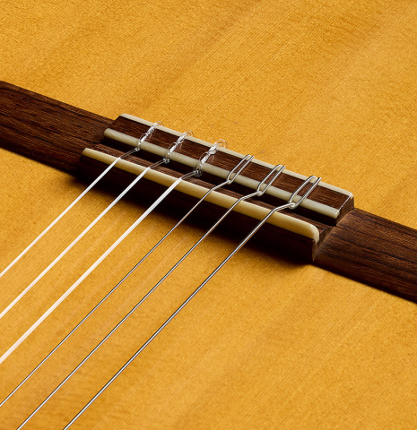 The bridge, tie-block and saddle of a 2001 Gary Southwell "1940 'Augustine' Hauser, ex-Bream" classical guitar made of spruce and Indian rosewood