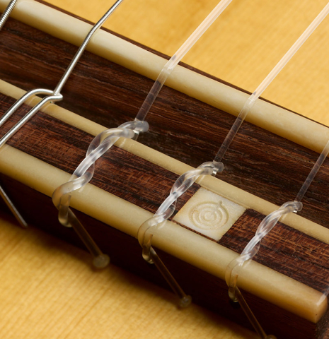 The bridge, tie-block and saddle of a 2003 Gary Southwell "A-Series" (ex Scott Tennant) classical guitar made of spruce and Indian rosewood