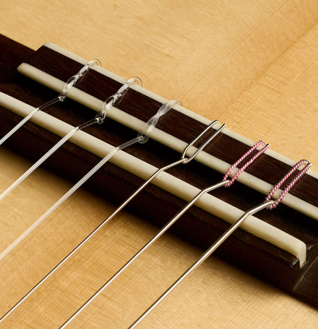 The bridge, tie-block and saddle of a 2025 Gary Southwell "1940 'Augustine' Hauser, ex-Bream" classical guitar made of spruce and Indian rosewood