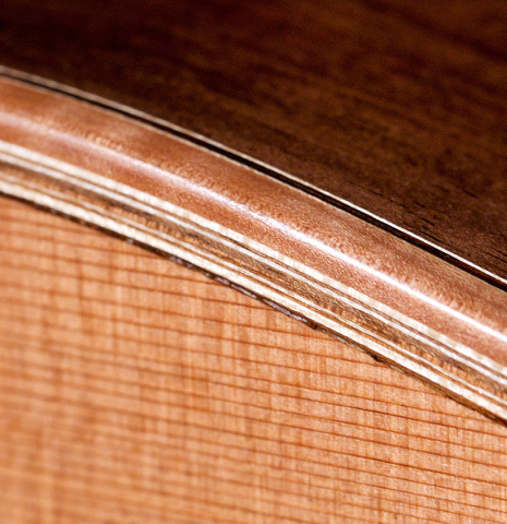 The binding and purfling of a 2020 Sebastian Stenzel &quot;Enhanced Wood&quot; classical guitar made with cedar and CSA rosewood.