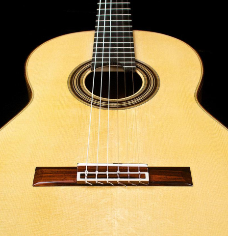 The soundboard of a 2017 Annette Stephany classical guitar made of spruce and Indian rosewood