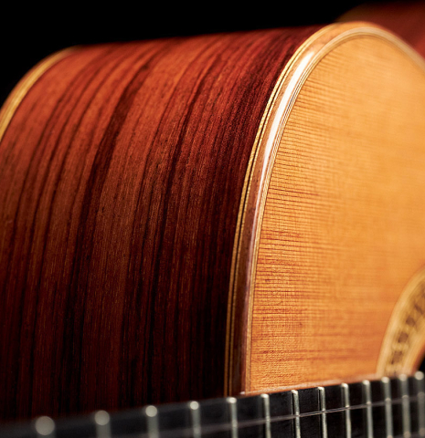 The side of a 2000 Sebastian Stenzel classical guitar made with cedar and Indian rosewood