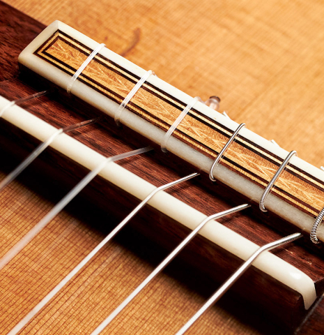 The tie block of a 2000 Sebastian Stenzel classical guitar made with cedar and Indian rosewood