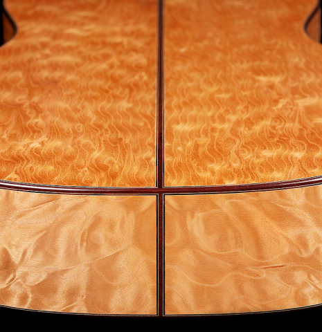 The back and sides at the foot of a 2024 Sebastian Stenzel classical guitar made of cedar and maple