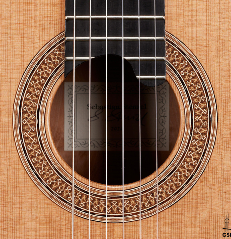 The rosette of a 2024 Sebastian Stenzel classical guitar made of cedar and maple