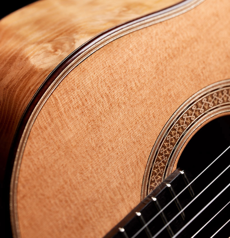 The top and rosette detail of a 2024 Sebastian Stenzel classical guitar made of cedar and maple