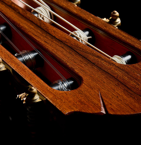 The headstock and tuning machines of a 2010 Sebastian Stenzel classical guitar made of spruce and African rosewood