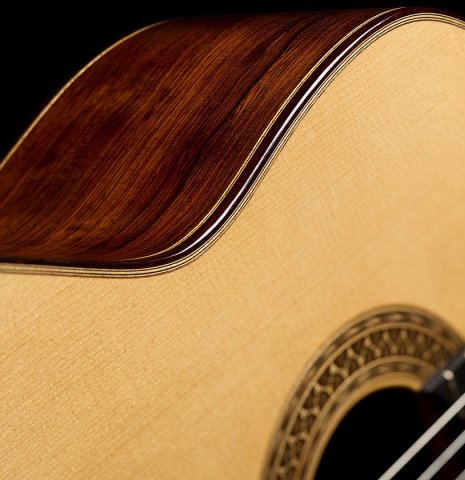 The soundboard and side of a 2010 Sebastian Stenzel classical guitar made of spruce and African rosewood