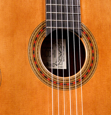 The soundboard and rosette of a 2022 Giovanni Tacchi classical guitar Friederich model made of cedar and Indian rosewood