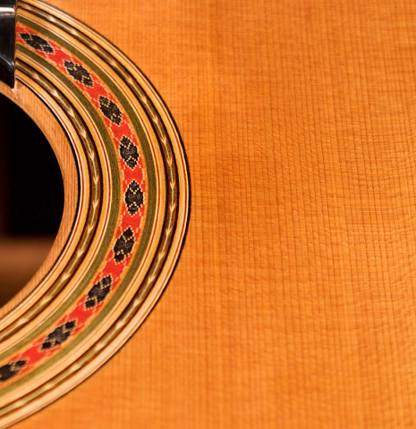 The soundboard and rosette of a 2022 Giovanni Tacchi classical guitar Friederich model made of cedar and Indian rosewood