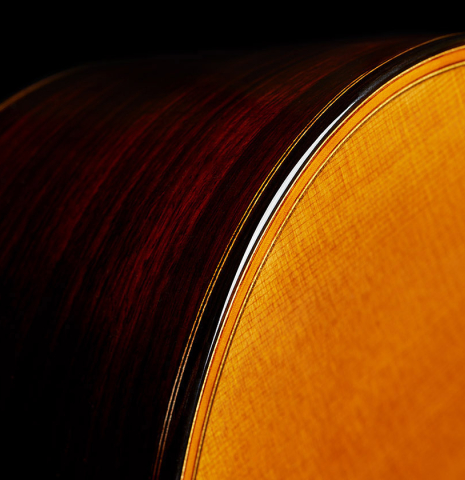 The soundboard binding of a 2024 Giovanni Tacchi classical guitar Friederich model made of cedar and Indian rosewood