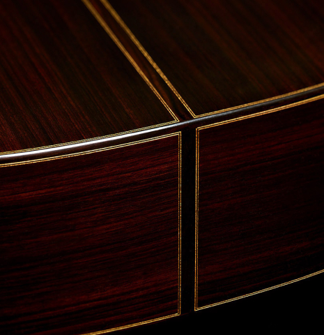 The sides at the foot of a 2026 Giovanni Tacchi classical guitar made of cedar and Indian rosewood