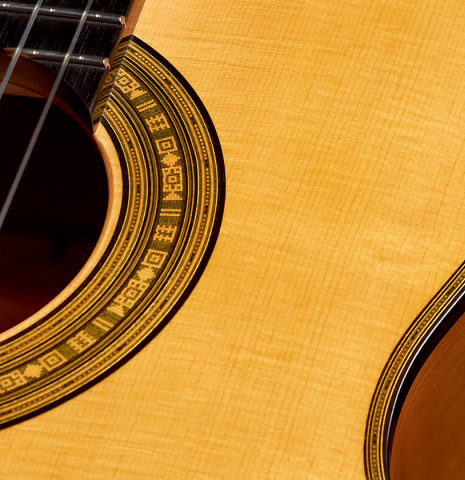 The rosette and soundboard of a 2022 Andrea Tacchi "Homage to the Spanish School" classical guitar made with spruce and cypress wood