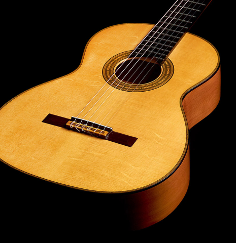 The front of a 2022 Andrea Tacchi "Homage to the Spanish School" classical guitar made with spruce and cypress wood