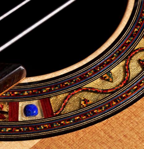 The rosette of a 2023 Andrea Tacchi "Coclea Thucea - Alter Ego" classical guitar with half cedar half spruce soundboard.