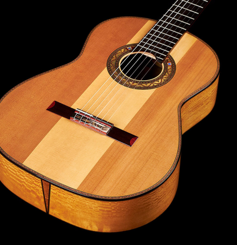 The half cedar half spruce soundboard of a 2023 Andrea Tacchi "Coclea Thucea - Alter Ego" classical guitar