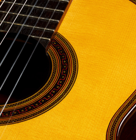 The soundboard and rosette of a 2006 Andrea Tacchi "Omaggio a Francisco Simplicio" classical guitar made of spruce and CSA rosewood